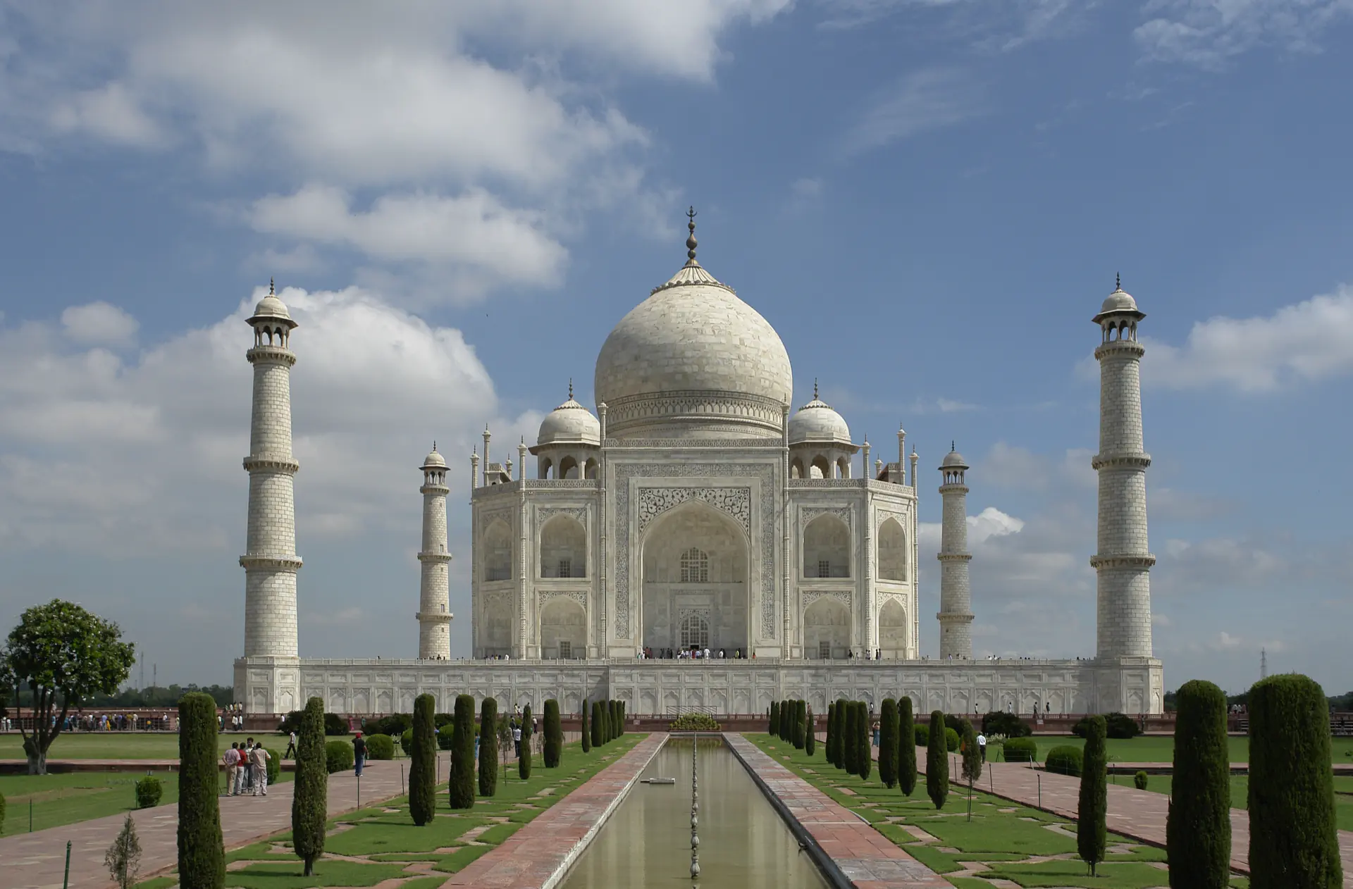 The Taj Mahal at the end of its watercourse, marble against an early sky.
