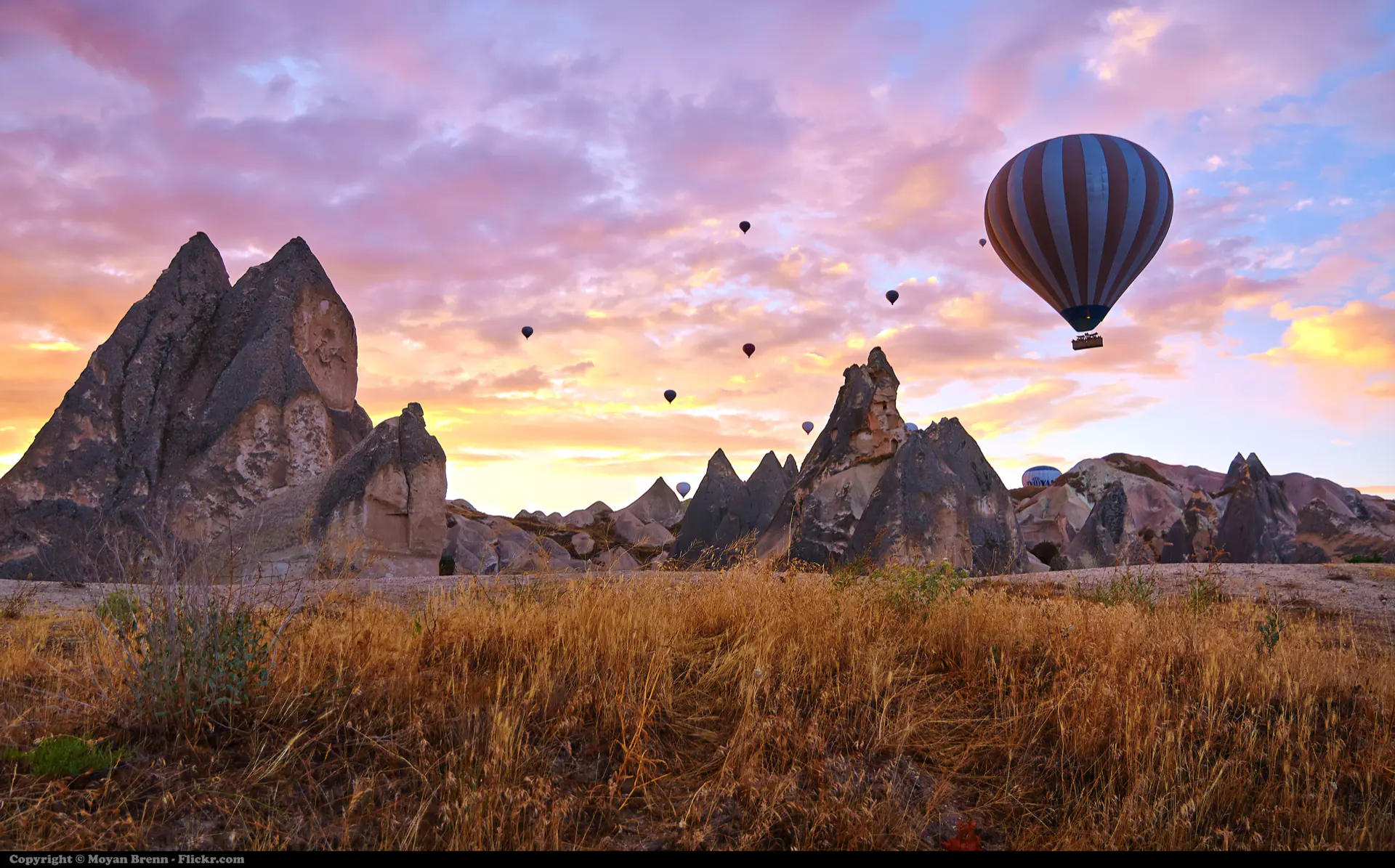 A single balloon over the fairy chimneys of Cappadocia at sunrise.