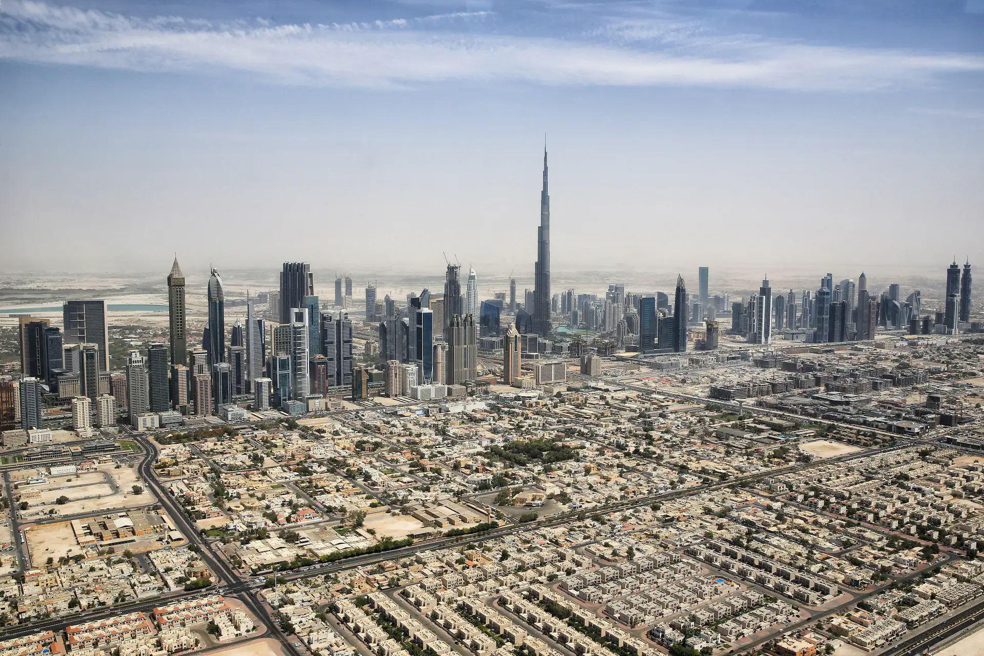 The Dubai skyline with the Burj Khalifa rising above Downtown at dusk.