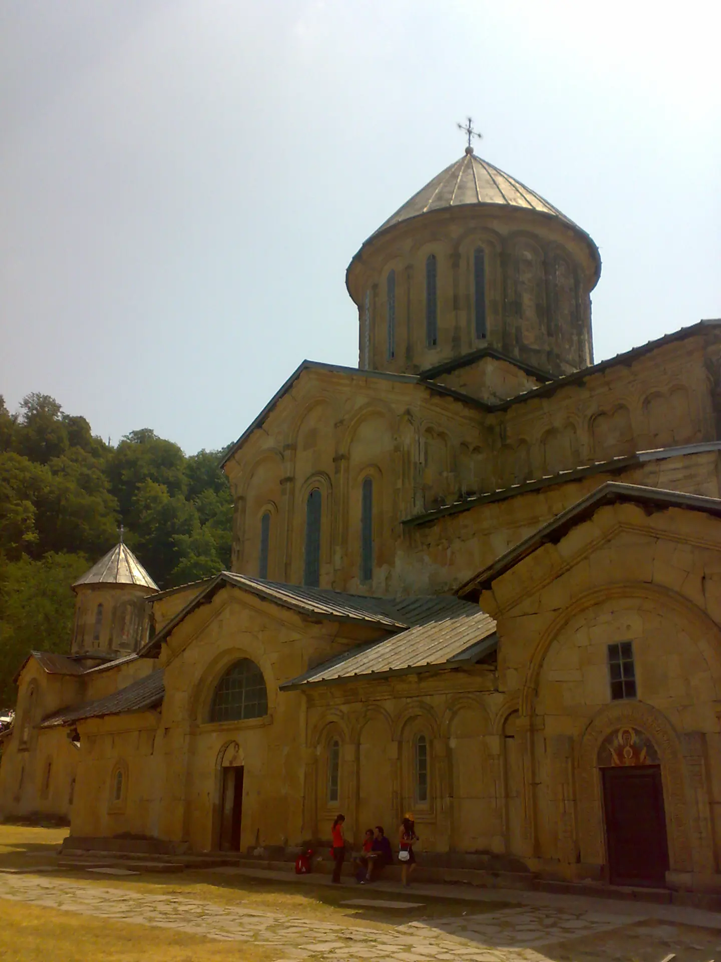 The medieval monastery church at Gelati above Kutaisi, stone domes among hills.