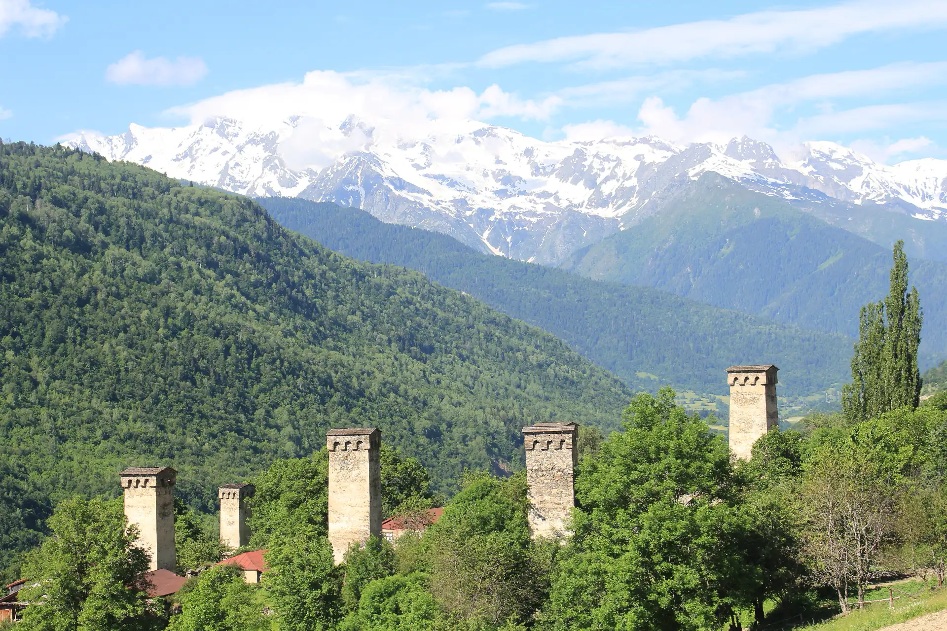 Svan defensive towers standing among houses below the high Caucasus.