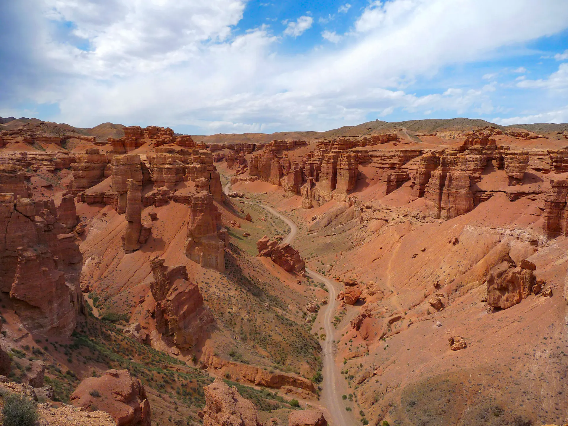 The red walls of the Valley of Castles in Charyn Canyon, a track along the floor.