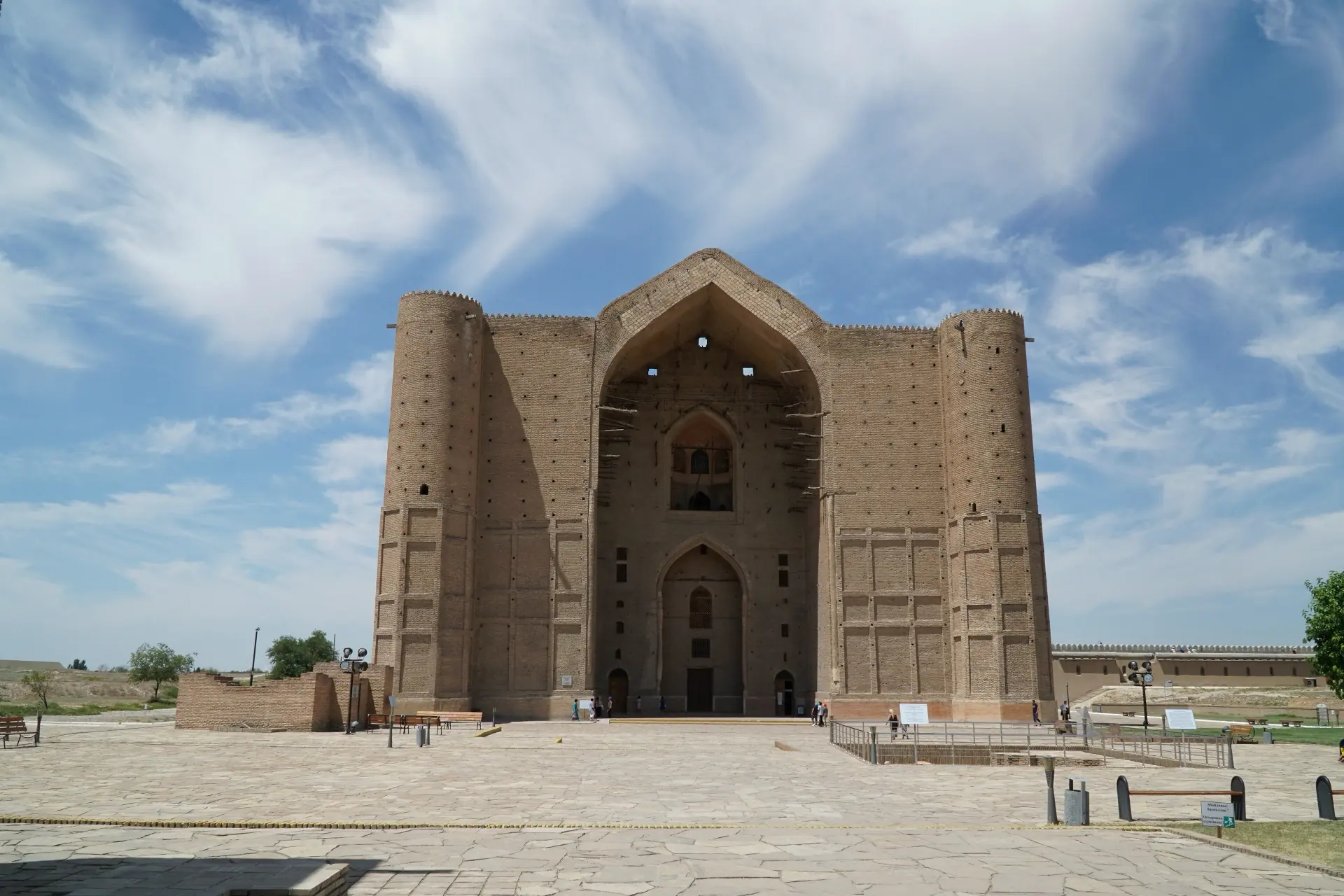 The unfinished brick façade and turquoise dome of the Yasawi mausoleum at Turkistan.