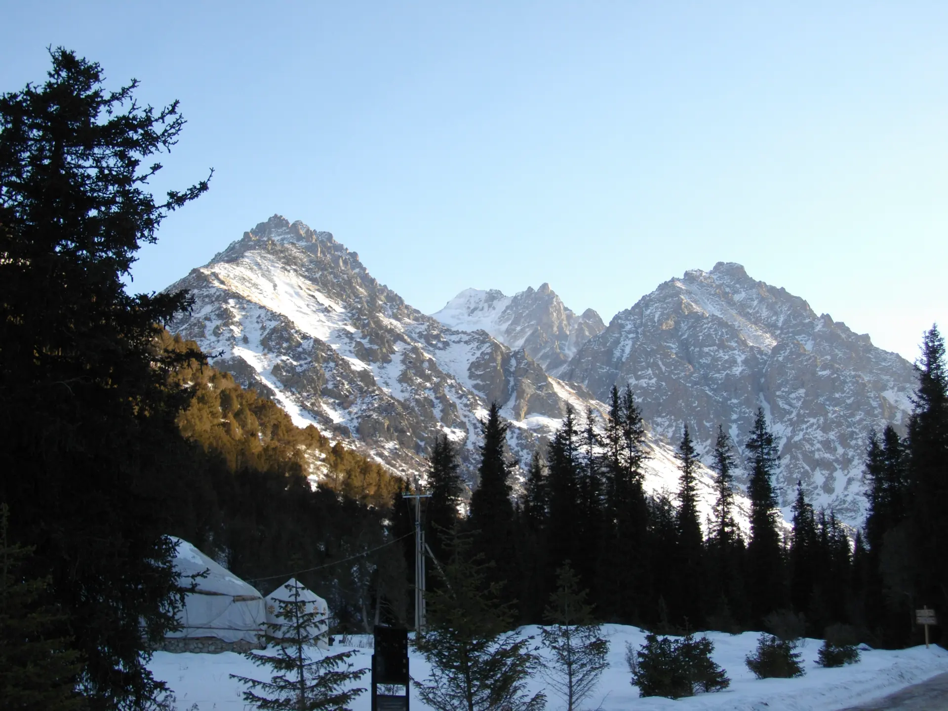 Snow-covered peaks and spruce forest in the Ala Archa gorge above Bishkek.