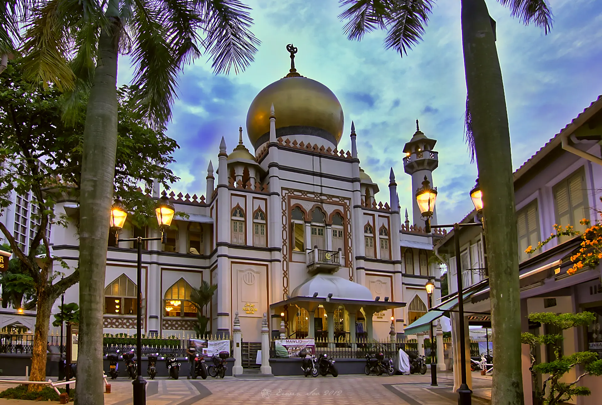 The golden domes of the Sultan Mosque at Kampong Glam at blue hour.