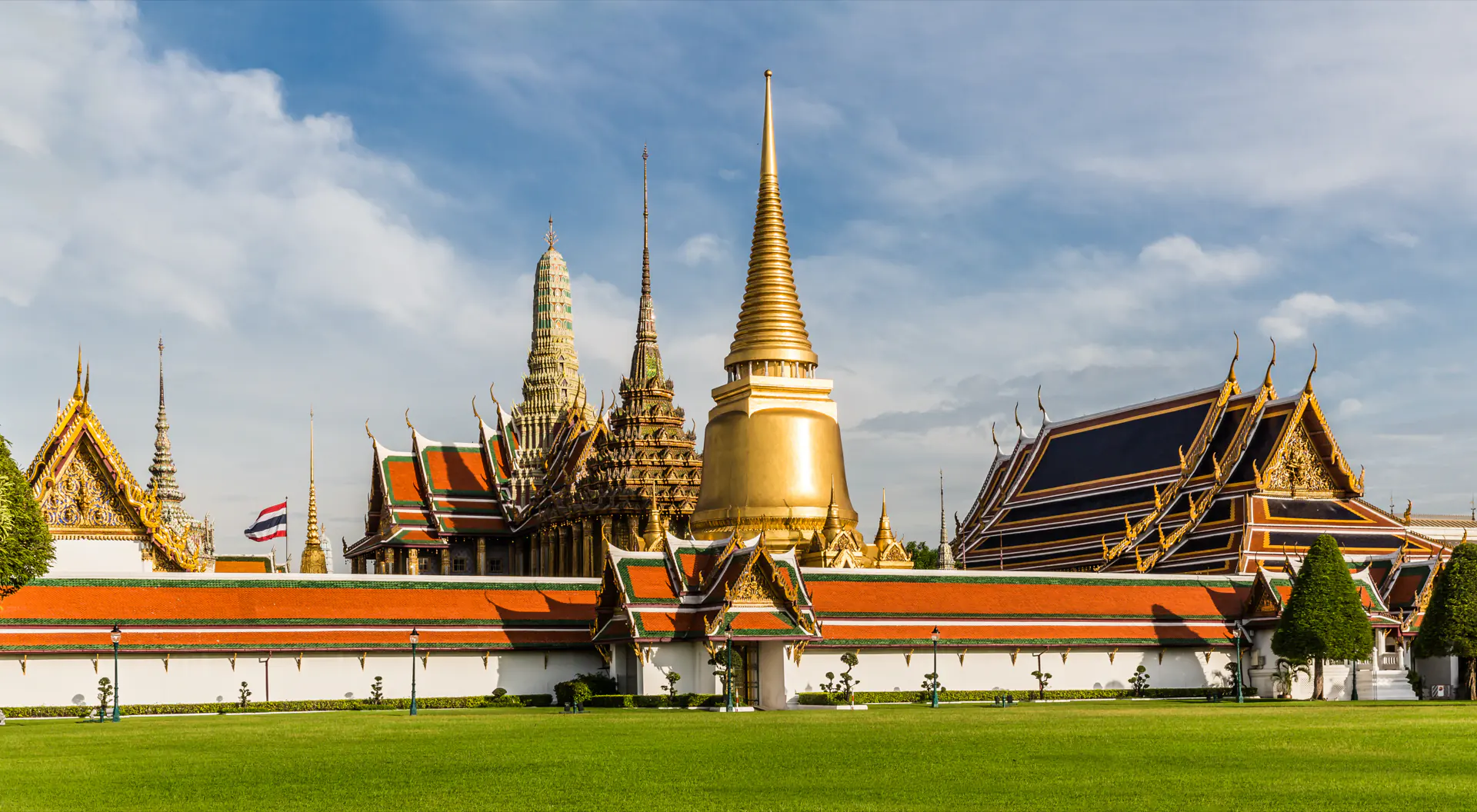 The gilded chedi and tiered roofs of Wat Phra Kaew inside the Grand Palace, Bangkok.