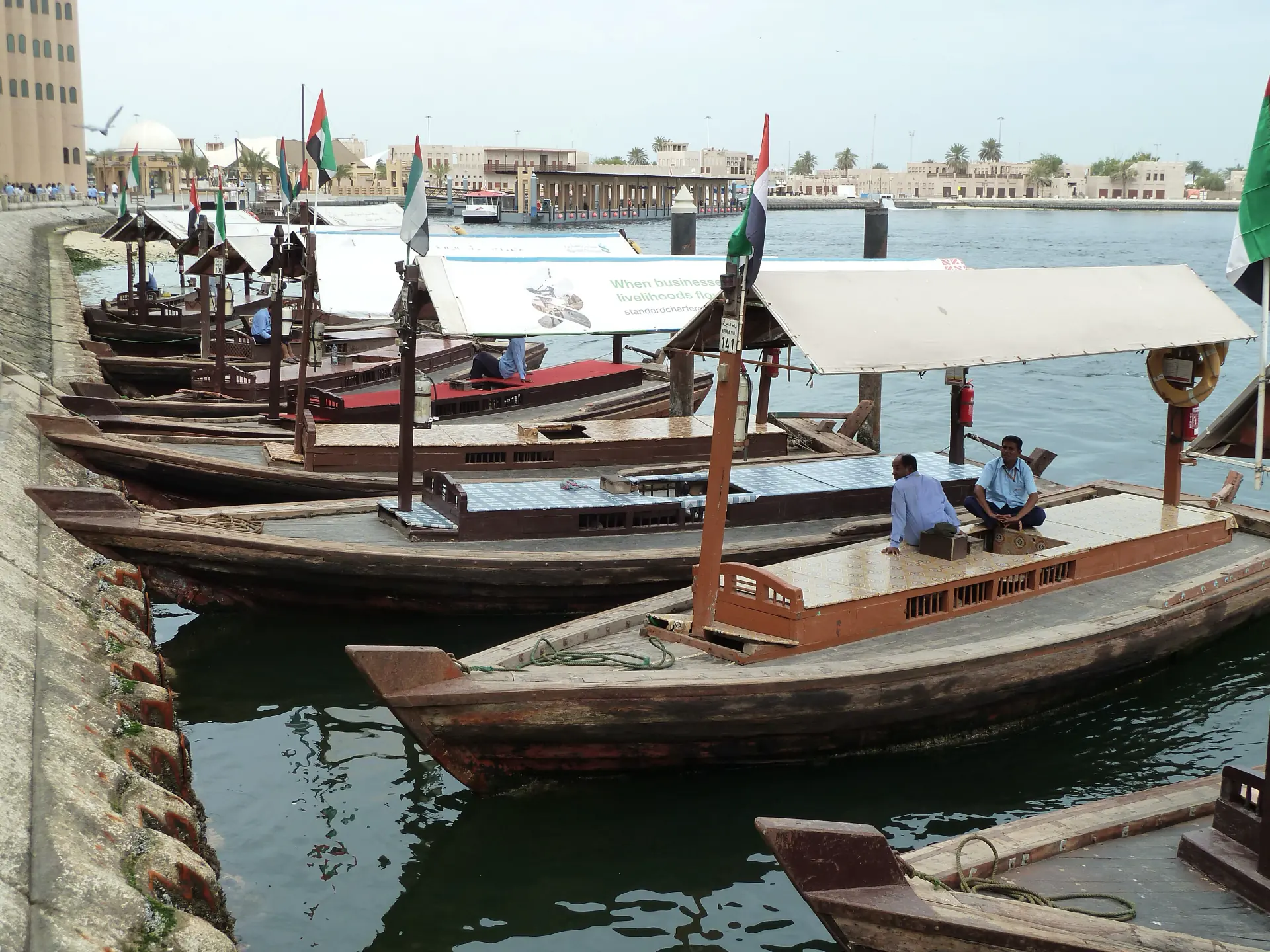 Wooden abras moored along Dubai Creek waiting for passengers.