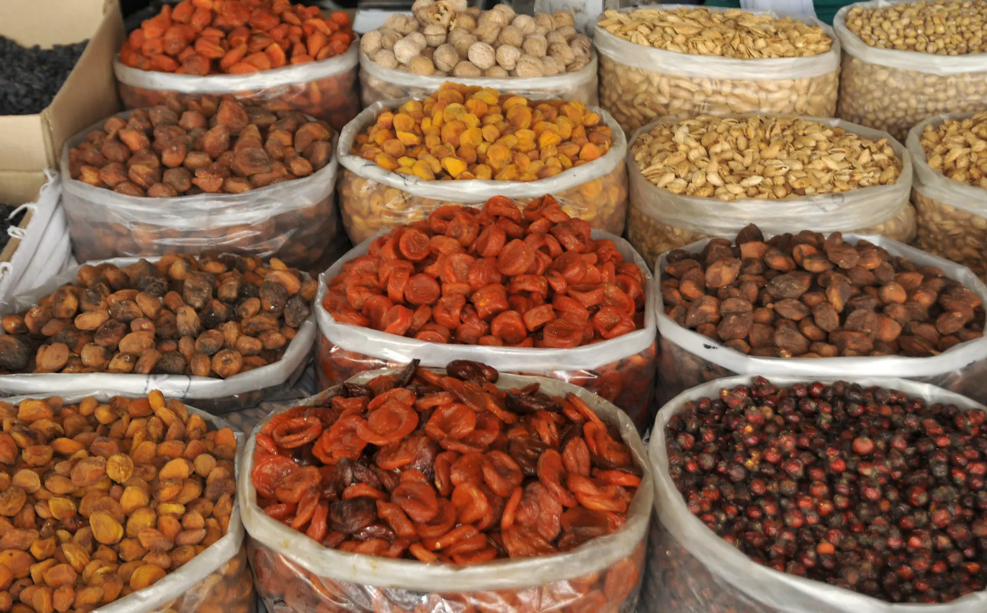 Stalls of dried fruit, nuts and spices under the dome of Chorsu bazaar, Tashkent.